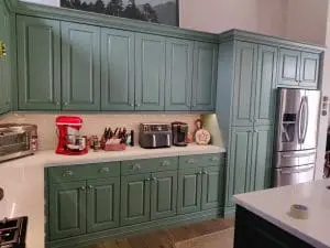 Refinished green kitchen cabinetry with white counters and stainless appliances in Scottsdale, AZ