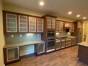 Kitchen cabinets masked off for cabinet refinishing preparation