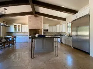Refinished white kitchen cabinets with custom island and built-in stainless refrigerator in Cave Creek, AZ