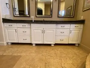 White painted double-sink bathroom vanity with dark granite counters in Phoenix, AZ