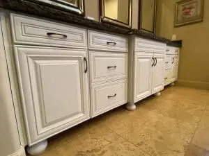 Refinished white bathroom vanity cabinets with dark granite countertops in Scottsdale, AZ