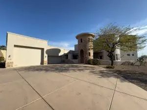 Freshly painted stucco exterior on custom Scottsdale home with turret entry