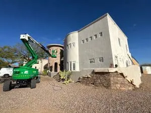 Hometown Painting team working with lift equipment on large Scottsdale home exterior