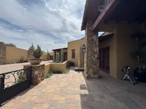 Custom desert-style entry courtyard with painted stucco and stone accents in Cave Creek, AZ