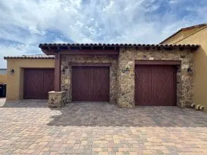 Stained wood garage doors on stone and stucco home in Cave Creek, AZ