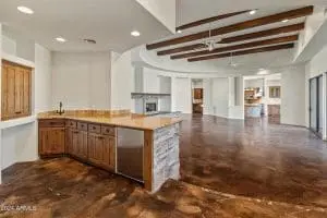 Interior painting in large open-concept living space with wood beams and natural finishes in Scottsdale, AZ