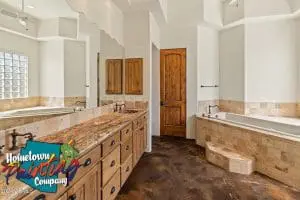 Fresh interior paint in rustic-style bathroom with wood cabinetry and stone tile in Scottsdale, AZ