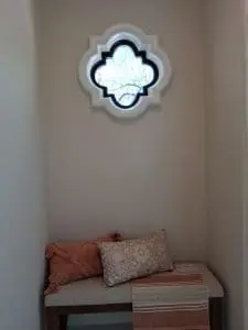 Painted accent nook with decorative window and bench seating in Scottsdale home