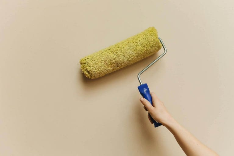 5 Signs It’s Time to Repaint the Exterior of Your Arizona Home Hometown Paint teams painting a soft yellow wall in home exterior